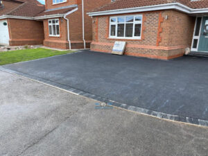 Tarmac Driveway with Charcoal Edging and Flower Feature in Hawarden